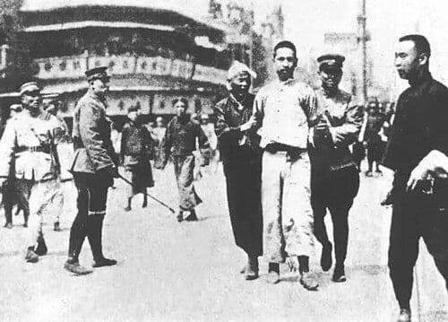 Communist-led workers arrested and led away by Kuomintang forces during the April 12 Massacre, Shanghai, April 1927.