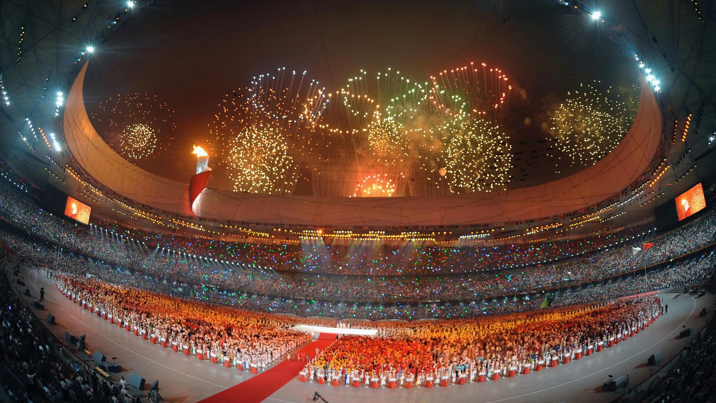 Fireworks in the shape of the Olympic rings light up the sky above the National Stadium ("Bird's Nest") during the opening ceremony of the Beijing Summer Olympics on 8 August 2008.
