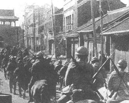 Japanese Kwantung Army troops march through the streets of Shenyang (Mukden) following the staged explosion on the South Manchuria Railway, 19 September 1931.